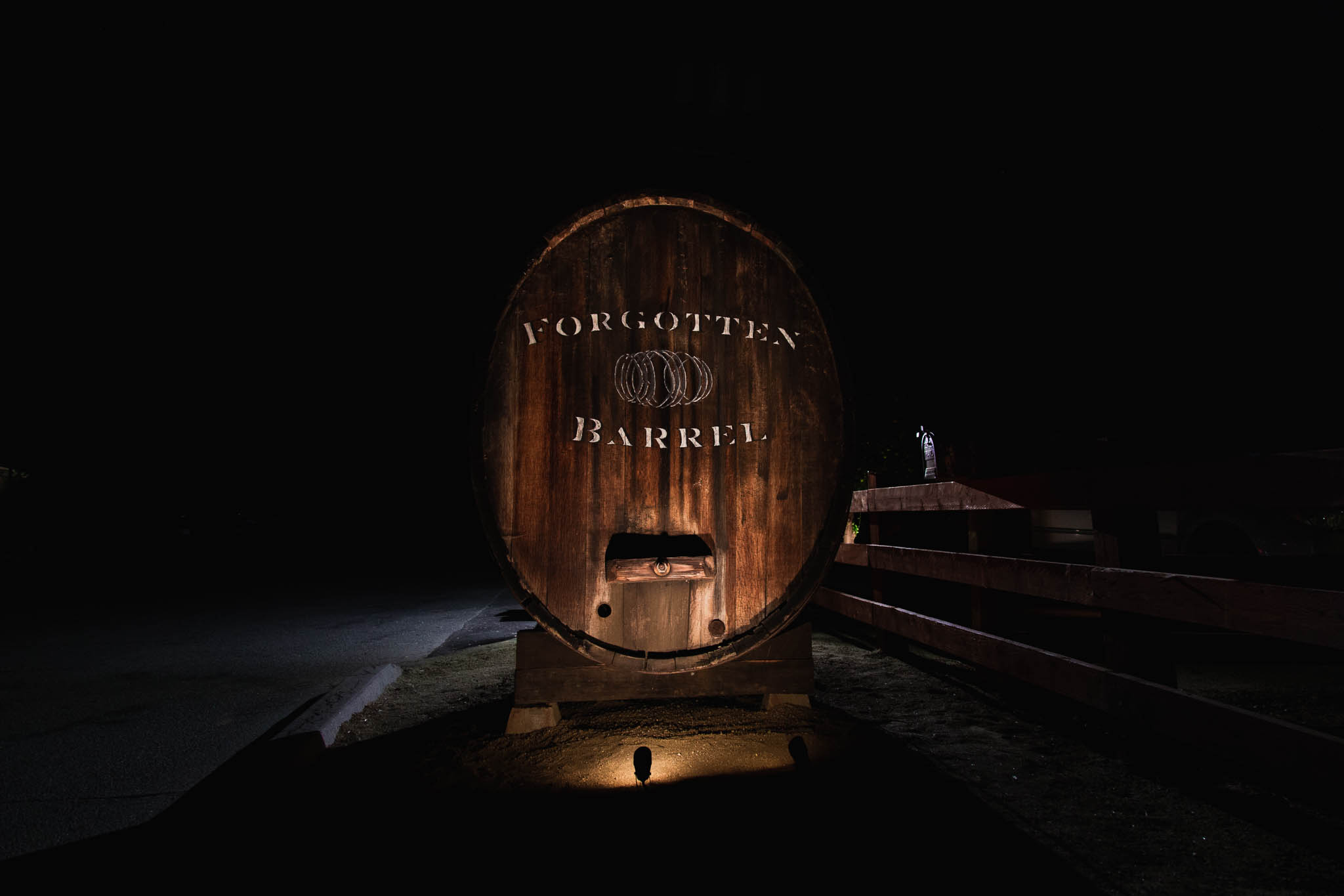 Handpainted Historic Barrel with Winery Branding Illuminated by light at night