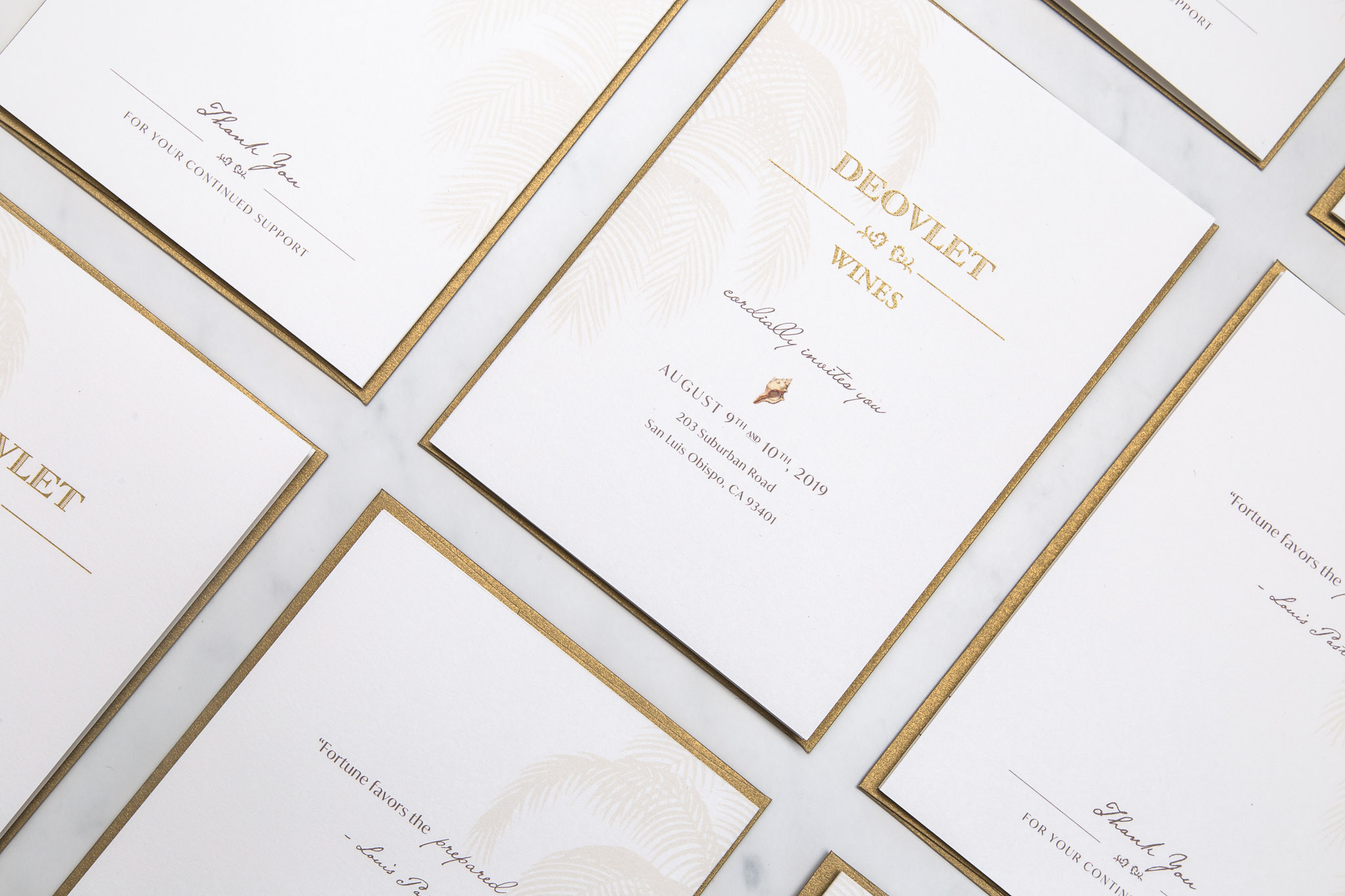 Flatlay of Deovlet Wines Custom Invitation Design for Carribean Inspired Winery Event